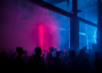 a group of people standing around in a room