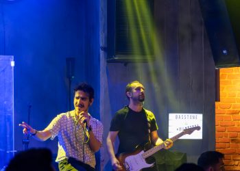 A group of men standing on top of a stage