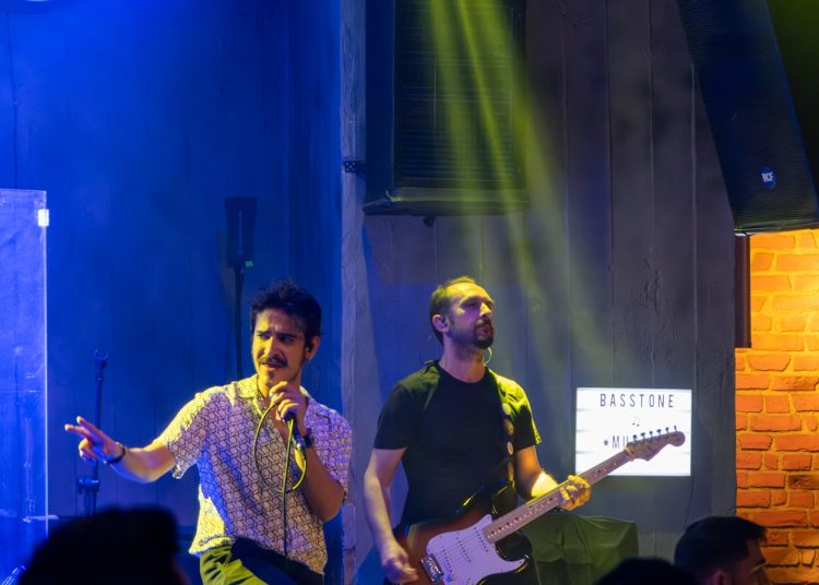 A group of men standing on top of a stage