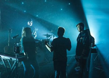 group of band members having discussion on stage