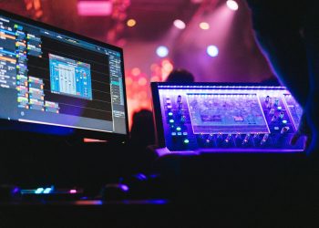 A person sitting in front of two computer monitors