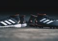 pair of black Adidas cleats
