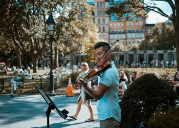 man playing violin at the park